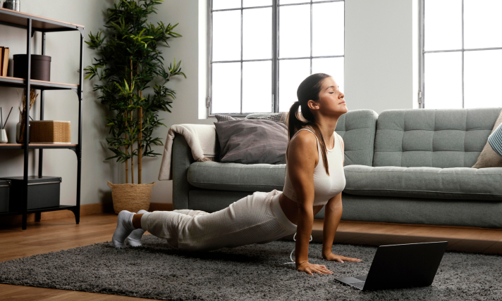 A woman doing yoga in her living room.