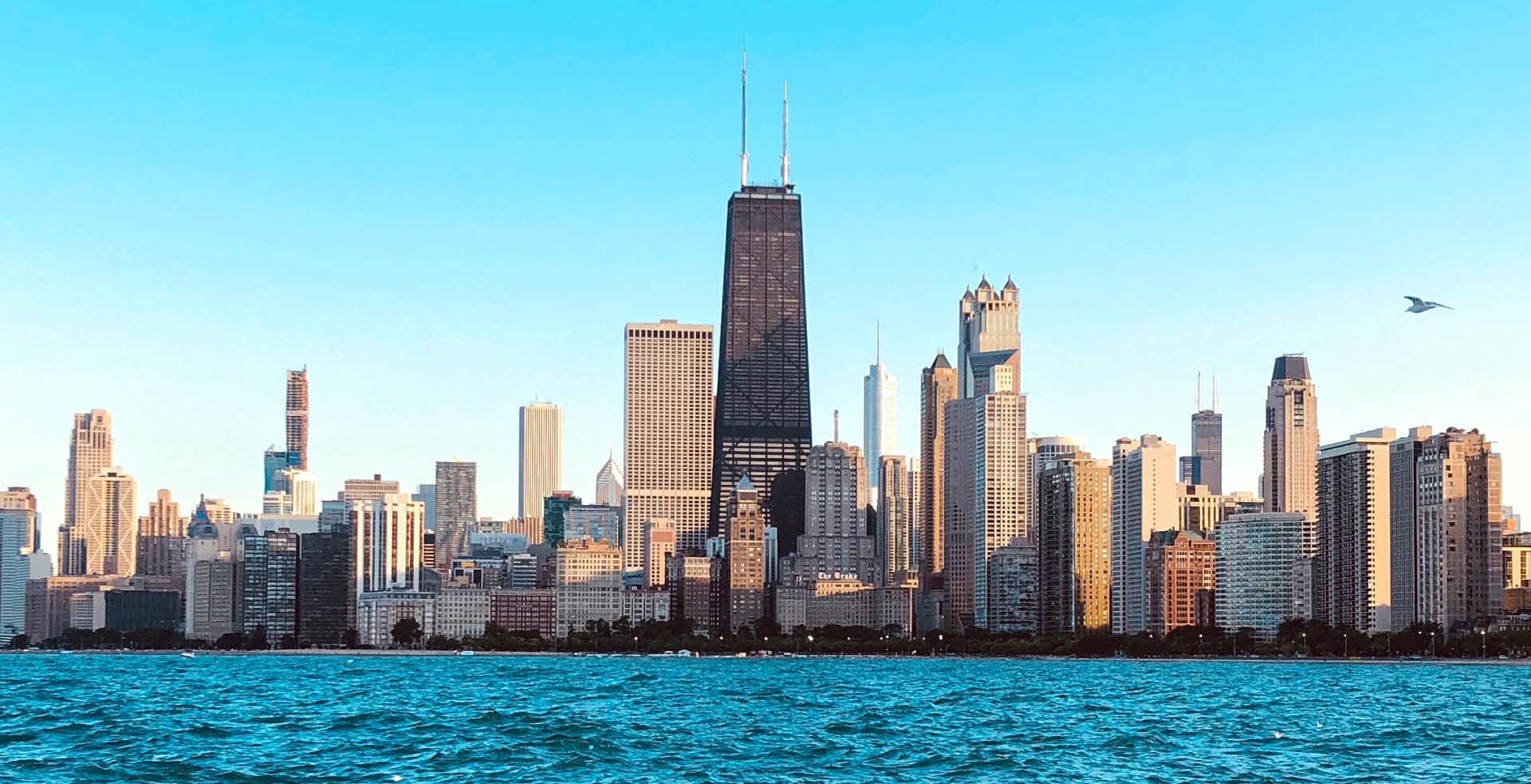 The Chicago skyline with Lake Michigan in the foreground.